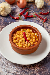 Hot turkish bean stew on wooden background. Ispir beans cooked in a casserole - Kuru Fasulye
