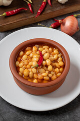 Hot turkish bean stew on dark background. Ispir beans cooked in a casserole - Kuru Fasulye