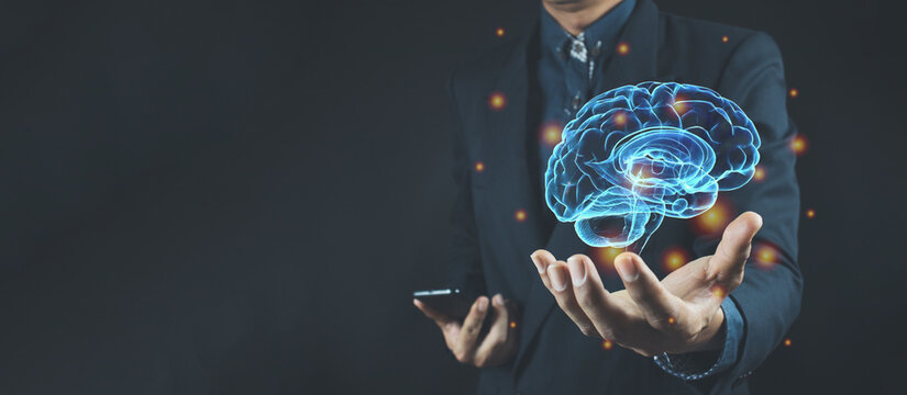 Businessman holding digital image of brain in palm
