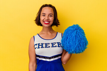 Young cheerleader mixed race woman isolated on yellow background happy, smiling and cheerful.