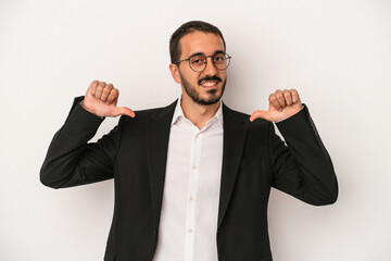 Young caucasian business man isolated on white background feels proud and self confident, example to follow.