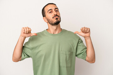 Young caucasian man isolated on white background feels proud and self confident, example to follow.