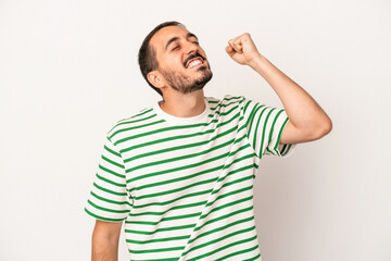Fototapeta premium Young caucasian man isolated on white background celebrating a victory, passion and enthusiasm, happy expression.