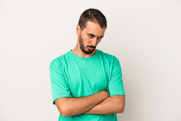 Obraz premium Young caucasian man isolated on white background tired of a repetitive task.