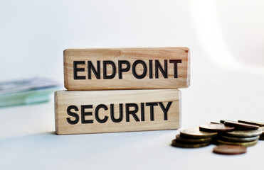 The inscription ENDPOINT SECURITY on wooden cubes isolated on a light background. Concept word forming on wooden cube. Business, economics and finance concept.