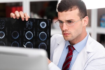 Doctor or scientist diagnosing patientâ€™s health on radiological chest x-ray film for medical...