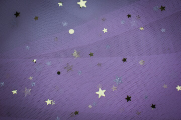 Light pink Crumpled festive tulle fabric (pink, purple, delicate) with sequins in the form of stars...