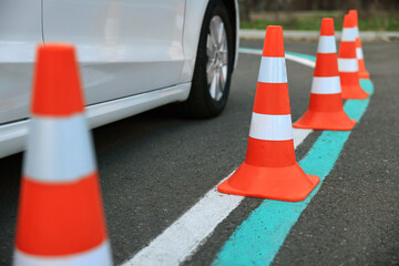 Modern car on test track with traffic cones, closeup. Driving school