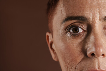 Senior ginger woman with short hair posing and looking at camera