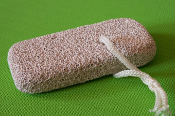 Rectangular block made of natural pumice stone for foot skin care.