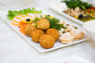 Snacks and dishes on the festive table. Reception of a large number of people in the restaurant.