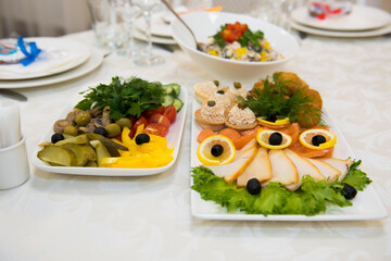 Snacks and dishes on the festive table. Reception of a large number of people in the restaurant.