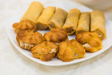 Pastries are different on the festive table. Culinary baked appetizer on dishes.