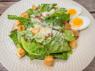 salad with mayonnaise and baked bacon and egg and vegetable dressing on top