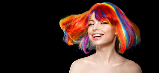 Woman hair as color splash. Rainbow up do short haircut. Beautiful young girl model with glowing  healthy skin on a black background