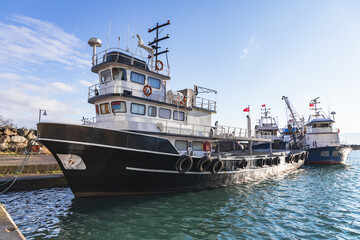 Fishing boat is moored in small fishing harbor. Turkey