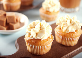 Homemade cupcakes with caramel syrup and whipped cream cheese
