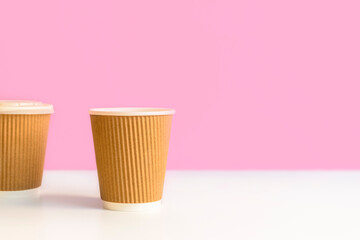 Reusable coffee cups on light pastel background with copy space. Eco-friendly concept