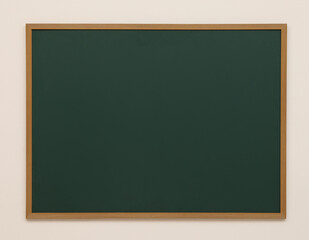 Clean green chalkboard hanging on white wall