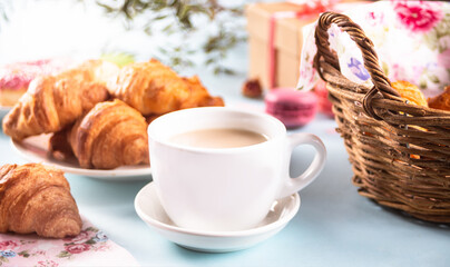 Fresh baked croissants and cup of tea. Healthy lifestyle concept.