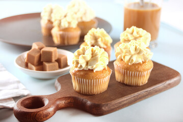 Homemade cupcakes with caramel syrup and whipped cream cheese