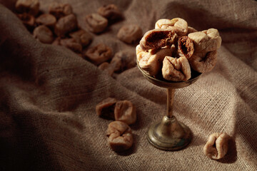Dried figs in an old brass dish.