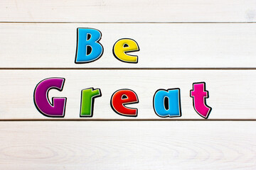 Be Great. Positive affirmation, statement. Bold neon letters on white washed background.
