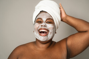 Happy curvy African woman having skin care spa day - People self care lifestyle concept