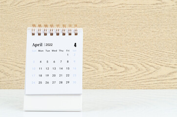 April 2022 desk calendar on the table.