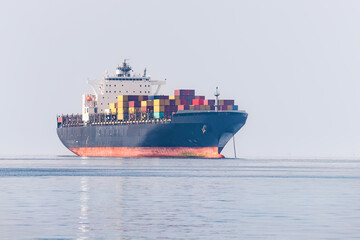A cargo ship delivers a lot of containers with goods from China. Sea shipment and transportation industry