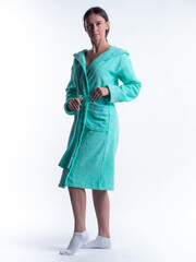 woman in a Bathrobe on an isolated white background with a smile on her face.