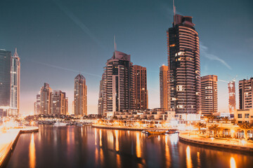 Fototapeta na wymiar DUBAI, UAE - FEBRUARY 2018: View of modern skyscrapers at night in Dubai Marina in Dubai, UAE.