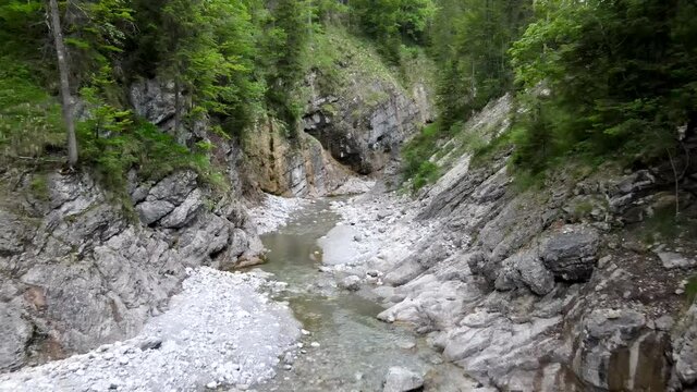 Small stream in a canyon in the bavarian alps, Aerial drone shot in 4k, gorge gulch ravine river