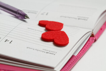 Red hearts for valentines on notebook, detail and concept for valentines day. Valentines day. Calendar for date february 14, 2022, Monday. 