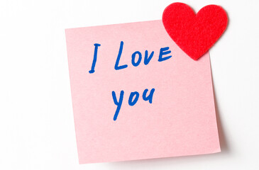 Text I love you on short note paper. A close up of a sticky note with the word I Love You with red heart. Valentine's Day. Valentine's Day background. I love you lettering text. love concept