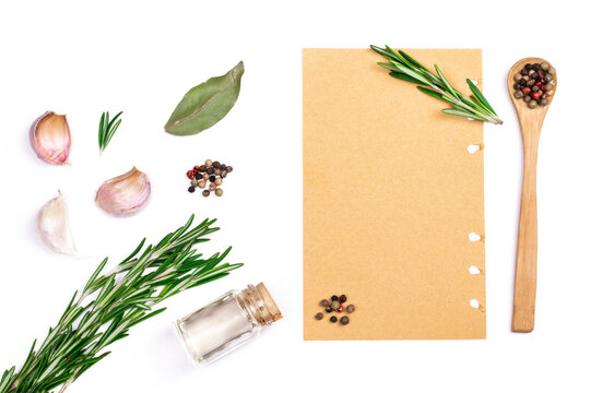 Various herbs, spices and paper blanc for menu on white isolated background. Top view image with copy space.