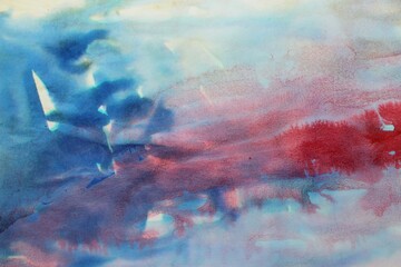 Red and blue watercolor background. Transparent lines and spots. Paint leaks and ombre effects. Abstract hand-painted image.