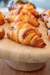 Irresistible Aromas and Flavors of Fresh French Bakery Delights, Served on a Rustic Wooden Board at a Hotel Breakfast