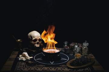 Esoteric mystical still life with a  burning altar bowl, pentagram, books, skull, potions and...