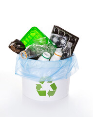 separate collection of sorted PET plastic bottles in bucket for recycling. Polyethylene terephthalate recyclable containers on white background. Plastic garbage. Save the planet.