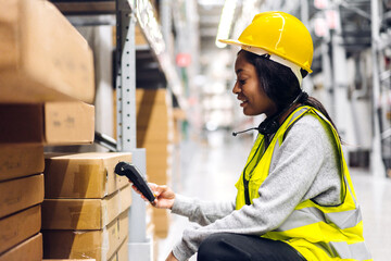 Portrait of african american engineer woman scanning package with barcode scanner check goods in transportation and distribution in warehouse.logistic Industrial and business export.