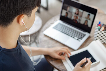 Online studying concept the young company man who puts a computer laptop on the wooden table being...