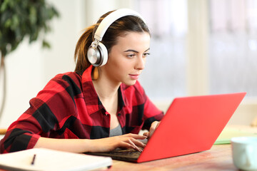 Student e-learning with laptop and headphones at home