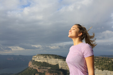 Woman breathing fresh air a windy day in nature