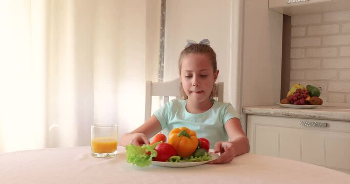 the child eats vegetables with pleasure. The girl eats healthy food. the concept of children's health