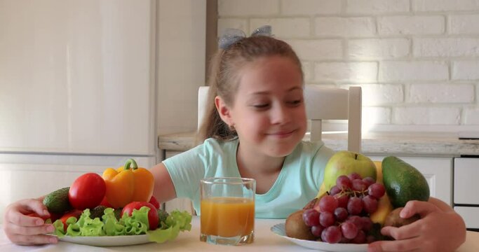 the child eats vegetables with pleasure. The girl eats healthy food. the concept of children's health