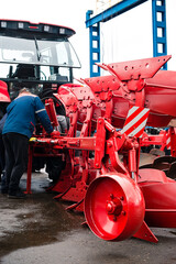 The farmer repairs the harrows, master welder welds metal parts of agricultural equipment.