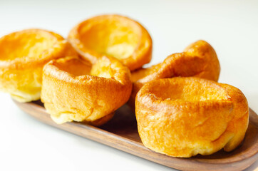 Obraz na płótnie Canvas Traditional English Yorkshire pudding, wonderfully crisp and golden baked for a traditional recipe, accompaniment for the perfect Sunday roast