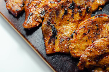 Fresh and juicy pork loin steaks,  grilled meats on the wooden board