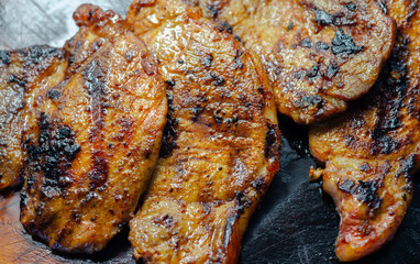 Fresh and juicy pork loin steaks,  grilled meats on the wooden board
